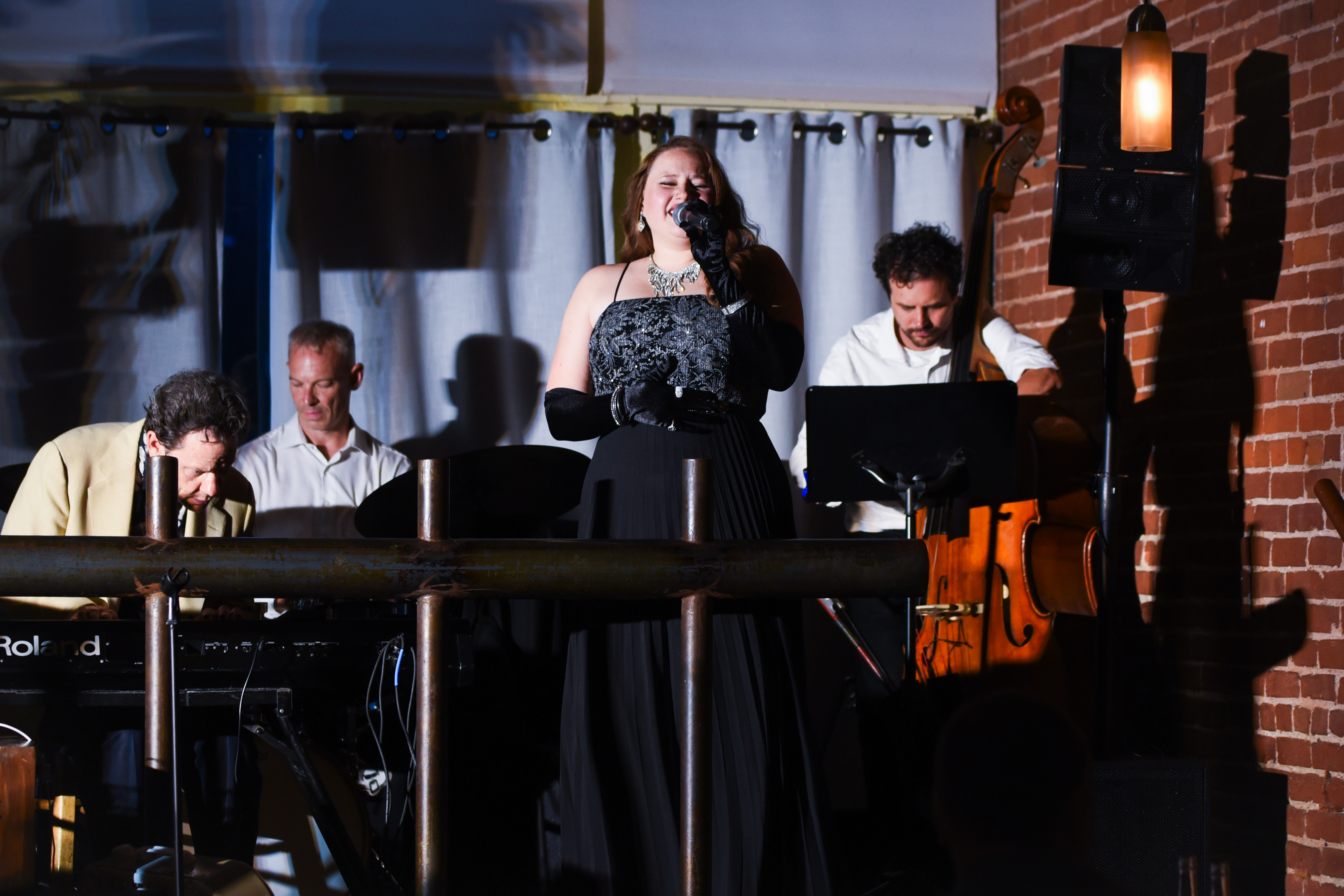Live band performing at Café 333 with vocalist, pianist, and upright bass